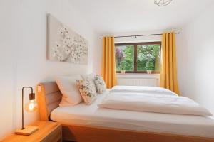 a bedroom with a bed and a window at Apartment am Bischofsberg in Großheubach