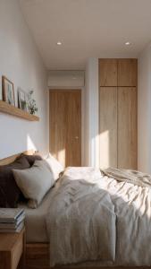 a bedroom with a bed and a wooden cabinet at the ockta omeah 2 in Semenyih