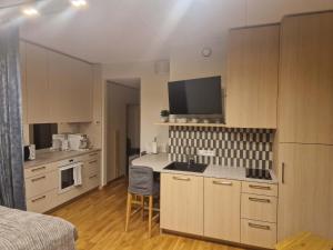 a kitchen with white cabinets and a counter top at Oja 69-4 Apartment in Pärnu