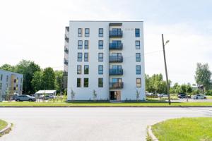 a white building with a street in front of it at Oja 69-4 Apartment in Pärnu +9 photos
