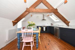 a kitchen with a blue table and chairs at High Field Cottage Rosscarbery in Rosscarbery