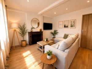 a living room with a couch and a fireplace at Au Morvan Voyageur in Asquins