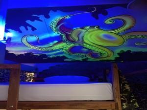 a mural of a green dragon on a blue wall at Peacock Hostel in Ko Lanta