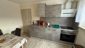 a small kitchen with a sink and a stove at Ferienwohnungen Stollhof in Mehring