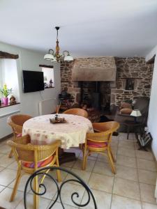 a dining room with a table and a fireplace at PhilVik in Lannion