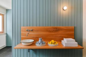 a bathroom with a counter with a bowl and a sink at Gasthof Rössle in Braz