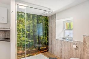 a glass shower in a bathroom with a window at Dommelhof Ferienwohnungen in Diemelsee +45 photos