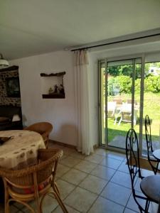a living room with a table and a sliding glass door at PhilVik in Lannion