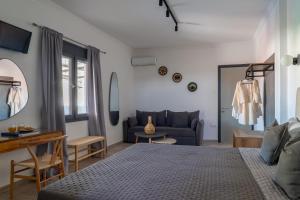 a bedroom with a bed and a couch at Central Guest House Skiathos in Skiathos
