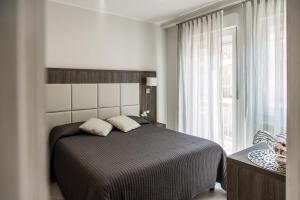 A bed or beds in a room at Versilia Residence