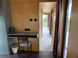 a home office with a desk and a chair in a hallway at ChillHouse 2 in Békésszentandrás
