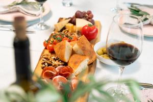 a table with a plate of food and a glass of wine at Oria Retreat in Danilovgrad +89 photos