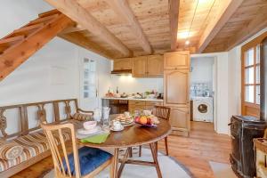 a kitchen and dining room with a table and chairs at Mille Colline la Casa 1 with Shared Pool - Happy Rentals in Pianezzo