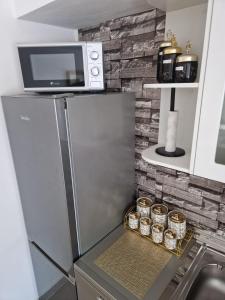 a kitchen with a refrigerator and a microwave at Stan na dan Alisa Cazin in Cazin