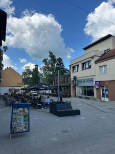 a town square with people sitting outside a building at Čaršija Light Visoko in Visoko