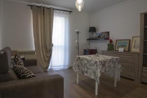 a living room with a table and a couch at Murazzanino in Murazzano