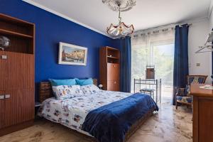 a bedroom with blue walls and a bed and a chandelier at Villa Montplaisir 180m² - Jacuzzi in Charmes-sur-Rhône +34 photos