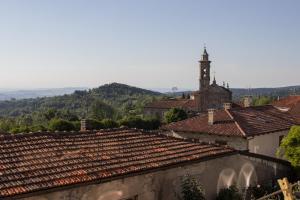 a view of a town with tile roofs and a church at Murazzanino in Murazzano