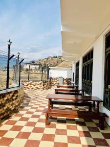 a row of wooden benches sitting on a building at Dema Rresort in Paro