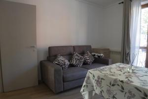 a living room with a couch and a table at Murazzanino in Murazzano +1 photo