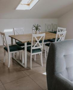 a dining room table and chairs with a wooden table and a table and chairsktop at Lovačka kuća Mandičevac in Mandičevac +8 photos