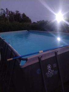 a swimming pool with a paddle on top of it at Neverland Deluxe in Santa Maria