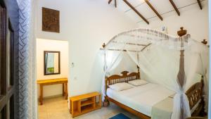 a bedroom with a bed with a canopy at Sigiriya River Side Villa in Sigiriya +76 photos