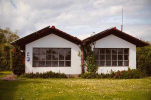 a white house with ivy growing around the windows at HolaCamp Luarca in Luarca +4 photos