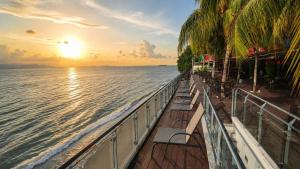 a view of the ocean from a cruise ship at sunset at Hompton Hotel by the Beach in George Town