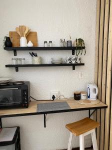 a kitchen with a counter with a microwave and shelves at Groenewald's Haven in Nelspruit +24 photos