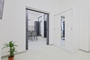 a view from the hallway of a house with white walls at Kasa KEK - MCMXXV in Mangalia +2 photos