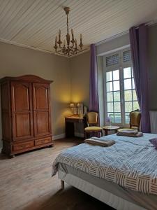 a bedroom with a bed and a dresser and a desk at Maison Vive La Vie in Couiza