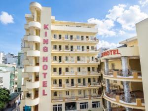 a tall building with a hotel sign on it at King Hotel Sầm Sơn in Sầm Sơn +23 photos