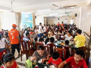 a crowd of people sitting at tables in a room at King Hotel Sầm Sơn in Sầm Sơn
