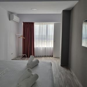 a bedroom with a bed with two white mitts on it at Olimp Panoramic Sea View in Olimp