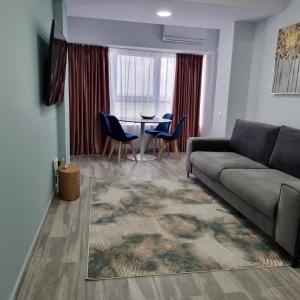 a living room with a couch and a table at Olimp Panoramic Sea View in Olimp +16 photos