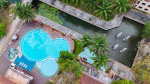 an overhead view of a pool with palm trees and water at Pung-Waan Resort & Spa in Kanchanaburi City +119 photos