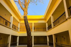 an empty building with a tree in the middle at Pung-Waan Resort & Spa in Kanchanaburi City
