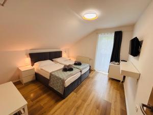 a bedroom with a bed with shoes on it at Hotel Pohorje in Maribor +87 photos