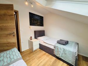 a small room with a bed and a small bed sidx sidx sidx sidx at Hotel Pohorje in Maribor