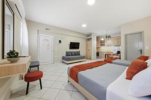 a bedroom with a large bed and a kitchen at Sivotahomes - Noah in Syvota