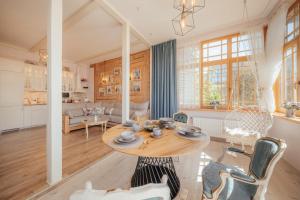 a kitchen and living room with a table and chairs at Sunset Lovers Residence in Liepāja