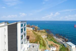 a view of the ocean from a building at Donghae 828 Spa Pension A in Donghae