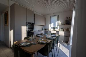 a kitchen with a wooden table and chairs in a kitchen at Retrait Lake Como Private Design Retreat with Lake View in Perledo