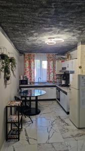 a kitchen with a table in the middle of it at Old City Cafe in Brăila