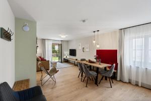 a living room and dining room with a table and chairs at Das BRIX I Apartments zwischen See & Wald in Immenstaad in Immenstaad am Bodensee