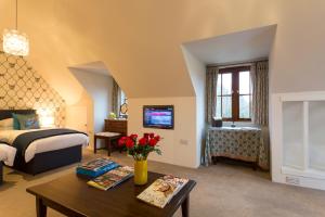 a bedroom with a bed and a table with flowers at Studio in the Field in Andover