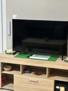 a flat screen tv sitting on a wooden entertainment center at Casa Kelly Chios in Chios