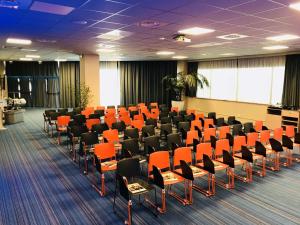 a conference room with orange chairs in the middle at ibis Styles Toulon Centre Port in Toulon +165 photos