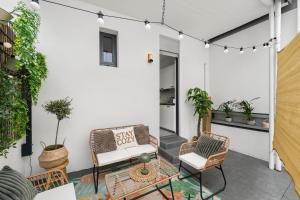 a patio with two chairs and a table at Stay COZY - The Lounge- Kingsize - Terrasse - Beste Lage in Aschaffenburg